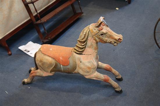 An early 20th century carved and painted wood carousel horse, W.39in. H.27in.